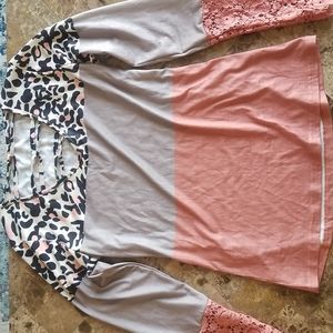 Long sleeve multi color top with detailed sleeves and criss cross neck.